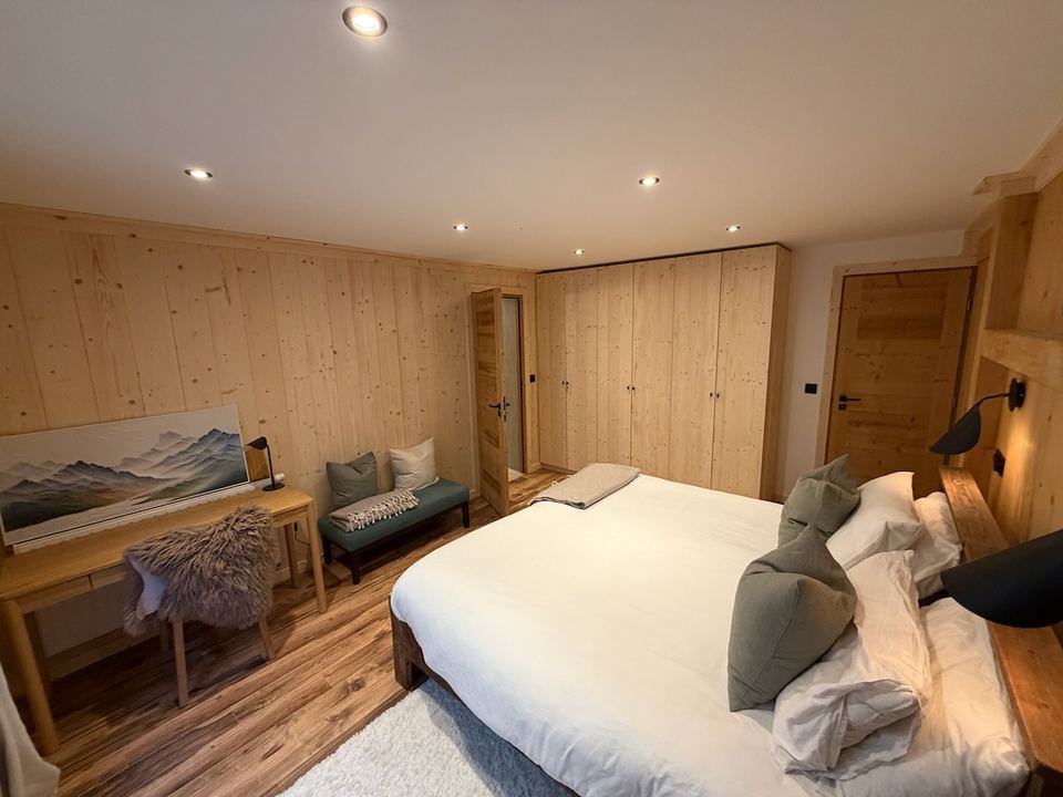 Master bedroom — wardrobes, a desk, and the new ensuite through the door.