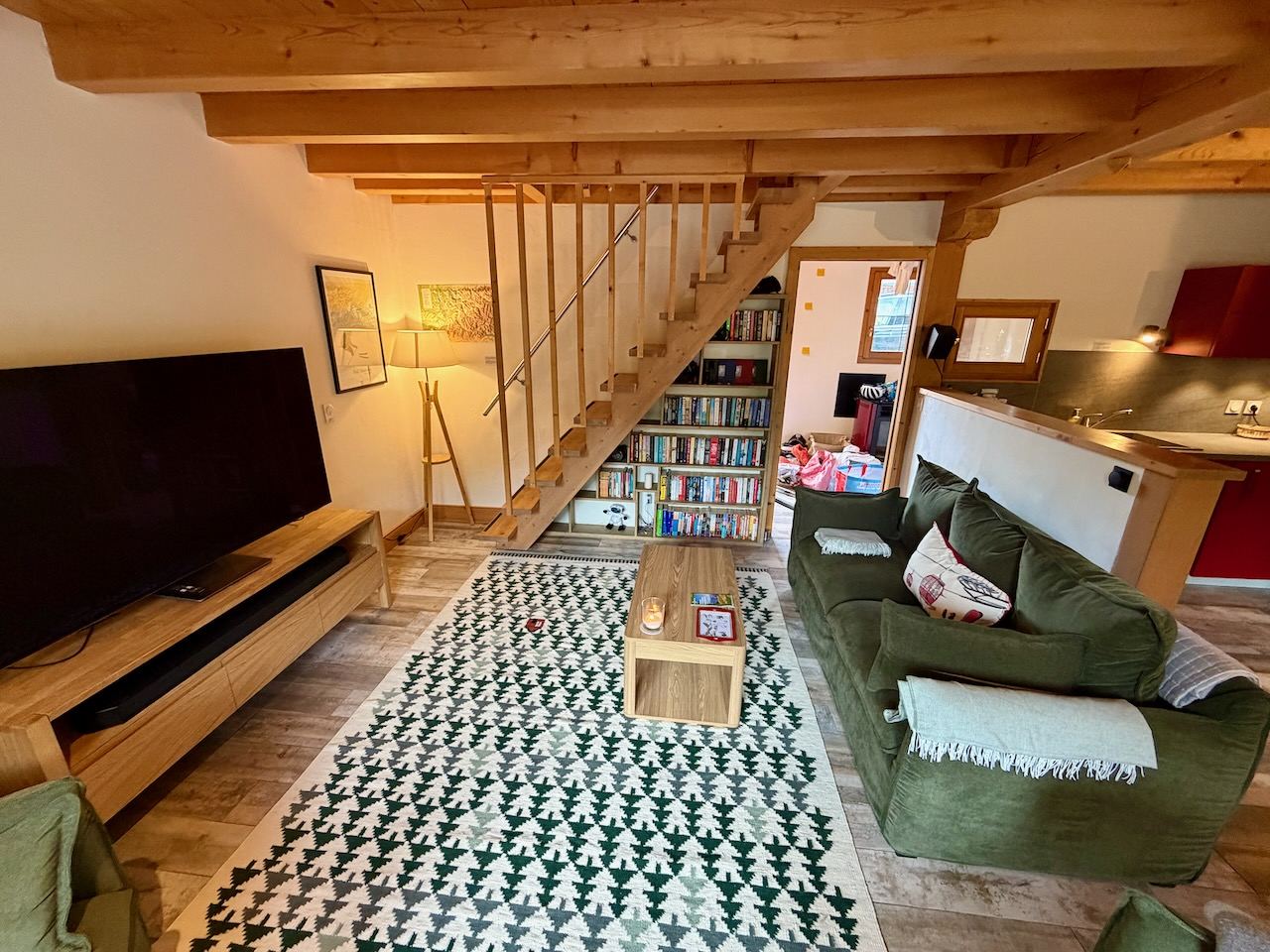 The living room, with the staircase up to the attic bedroom and a wall of books.