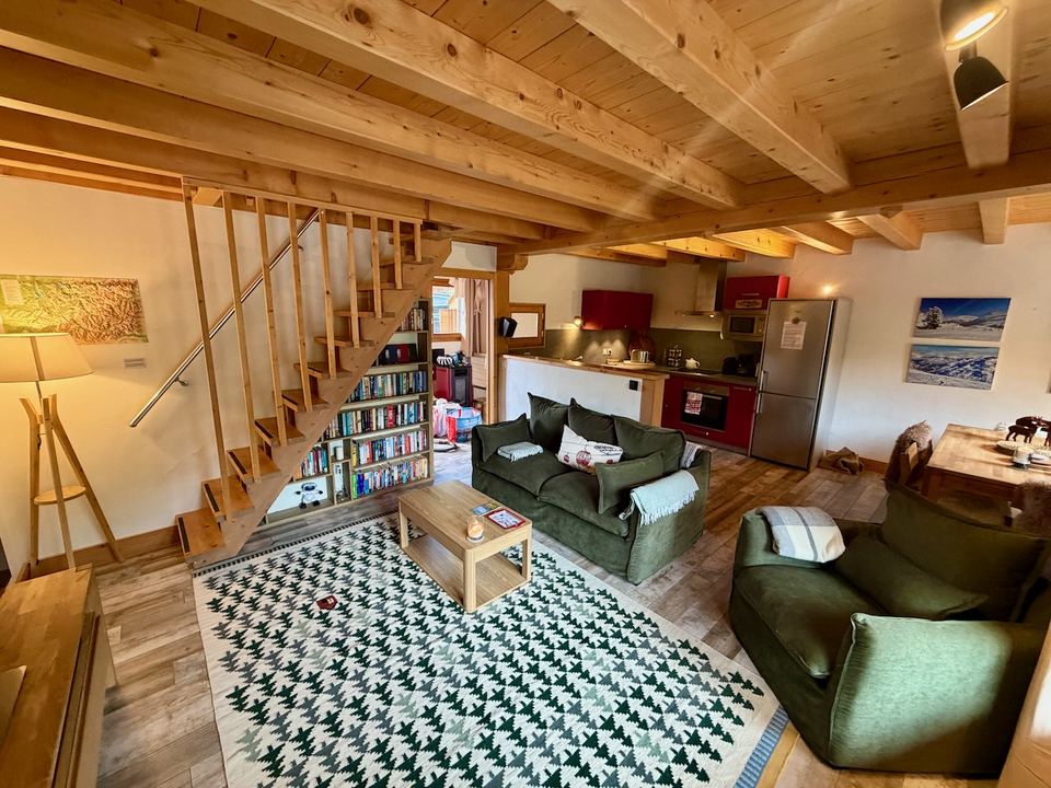 Open-plan living: new sofas, the bookshelves, and the kitchen behind.