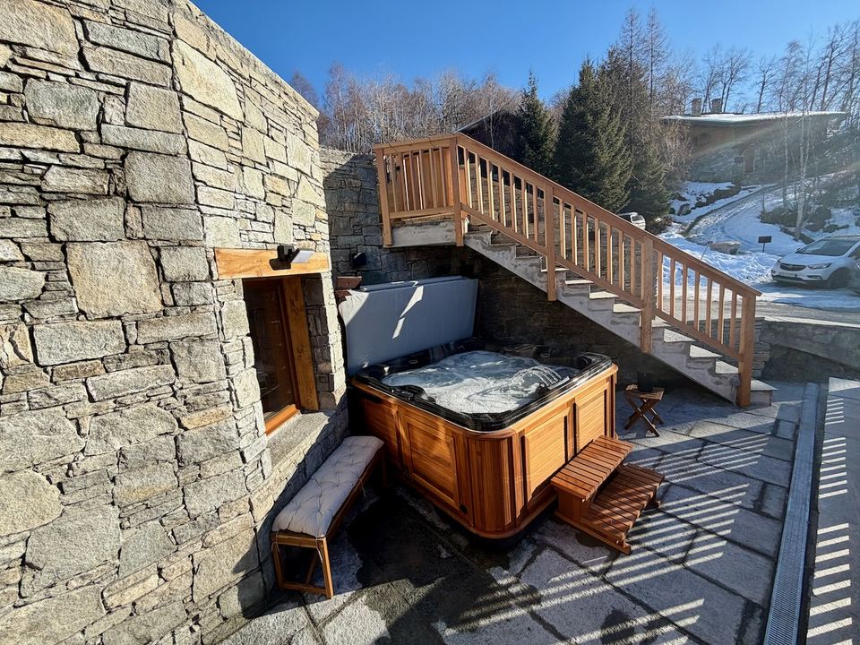 The lower terrace, with the hot tub and the outside stairs up to the top terrace.