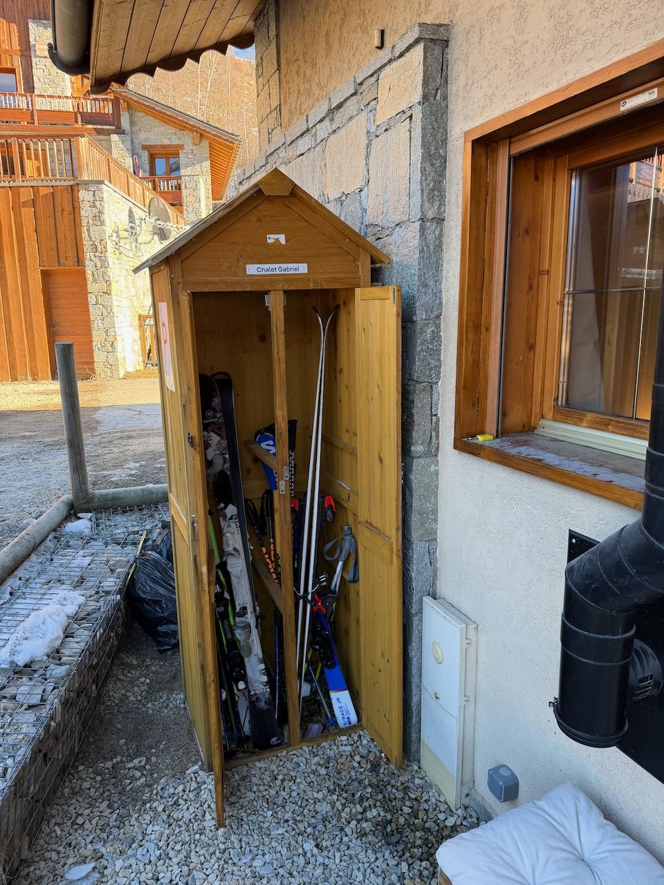 The chalet’s own lockable cupboard by the front door — skis, poles and boards.